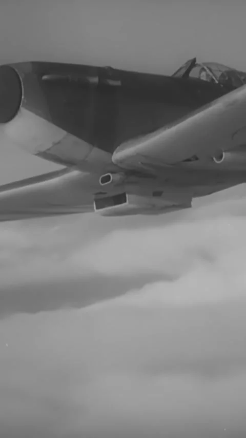 ENGLAND - 1940s - An RAF Spitfire flies through the clouds. Stock Footage 342257255