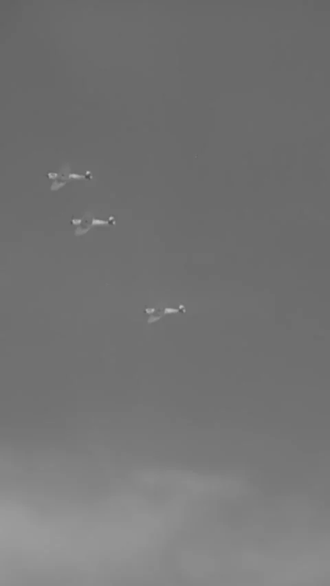 ENGLAND - 1940s - RAF Spitfires circle and fly through the clouds. Stock Footage 342257109