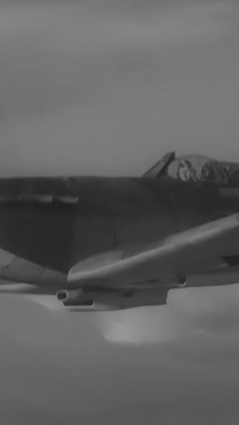 ENGLAND - 1940s - RAF Spitfires fly in formation through the clouds. Stock Footage 342257087