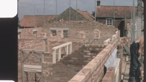 England 1970s, bricklayers working on upper walls of rural house Video stock 313118841