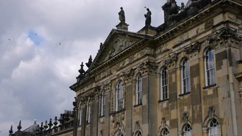 ENGLAND  CIRCA 2011: Side close view Howard Castle with birds swarming around Stock Footage 99619476