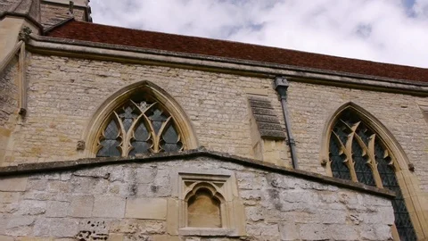 ENGLAND  CIRCA 2011: Tilt down from old english church to grave stones. Stock Footage 99625101