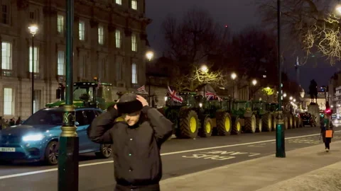England - December 11, 2024; Queue of tractors parked in the middle of the road Stock Footage 295692875