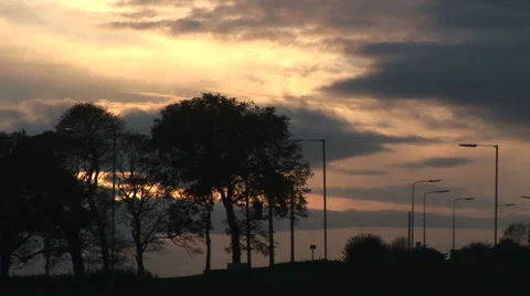 England sunset lampposts trees and cars 스톡 동영상 32133302