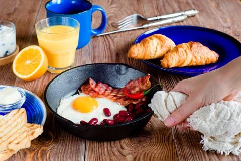 English breakfast in rustic style. first person view Stock Photos