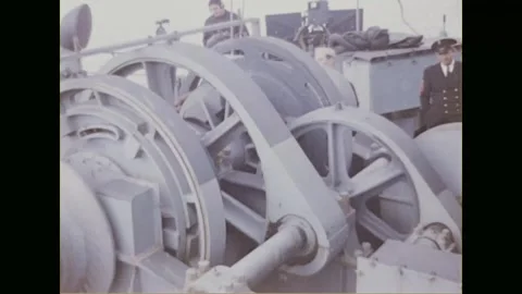 ENGLISH CHANNEL - 1944: a deck winch turns as officers stand behind Stock Footage 340234879