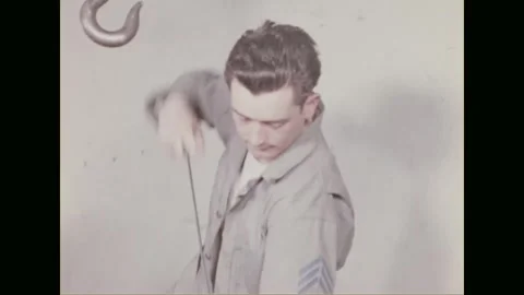 ENGLISH CHANNEL - 1944: a sergeant demonstrates cleaning and sighting a rifle Stock Footage 340234852