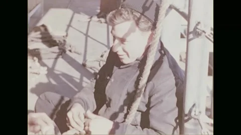 ENGLISH CHANNEL - 1944: weathered faces haul on the foredeck lines Vídeos de archivo 340234853