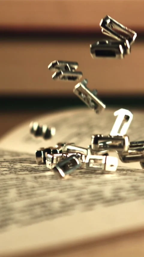 English letters fall on an open book. Filmed is slow motion 1000 frames per 库存影片 335287808