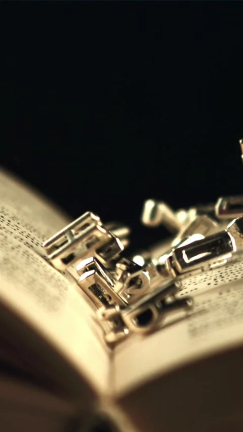English letters fall on an open book. Filmed is slow motion 1000 frames per 库存影片 335287860