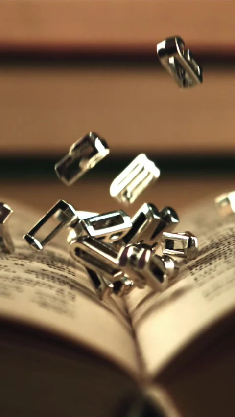 English letters fall on an open book. Filmed is slow motion 1000 frames per 库存影片 335288282