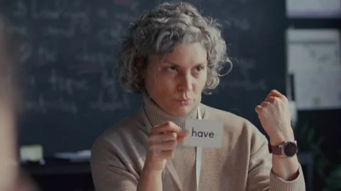 English Teacher Using Flashcard to Explaining Verb to Students during Lesson Stock Footage 295838886