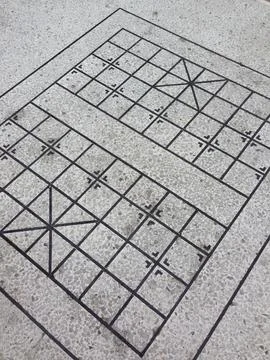 Engraved square grid pattern on terrazzo floor Stock Photos