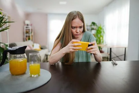 Engrossed in a captivating mobile game during a sunny afternoon Stock Photos