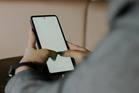 Engrossed Interaction: Person's Hands Navigating a Smartphone Screen Stock Photos