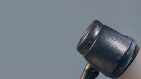 An engulfed in orange flame plastic wired earphone, placed on a matchstick and Stock Footage 264594596