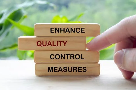 Enhance Quality Control Measures text on wooden blocks representing continu.. Stock Photos
