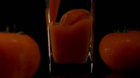 Enhanced taste. Super slow motion shot of pouring tomato juice into a Vídeos de archivo 147413083