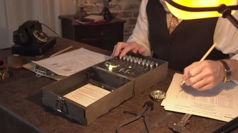 Enigma scientist looking at documents and decoding the machine Stock Footage 263767424