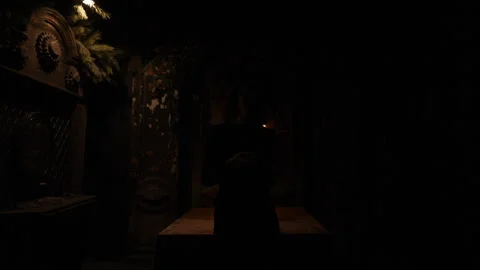 Enigmatic fortune teller in black robe shuffling Tarot cards standing in dark Stock Footage 275203310