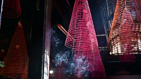 The Enigmatic Incense Spirals Burning Inside a Tranquil Temple Stock Footage 296348504
