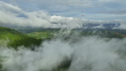 Enigmatic Vistas: Exploring Cloud-Enveloped Mountains in 4K Aerial Splendor Stock Footage 244474654