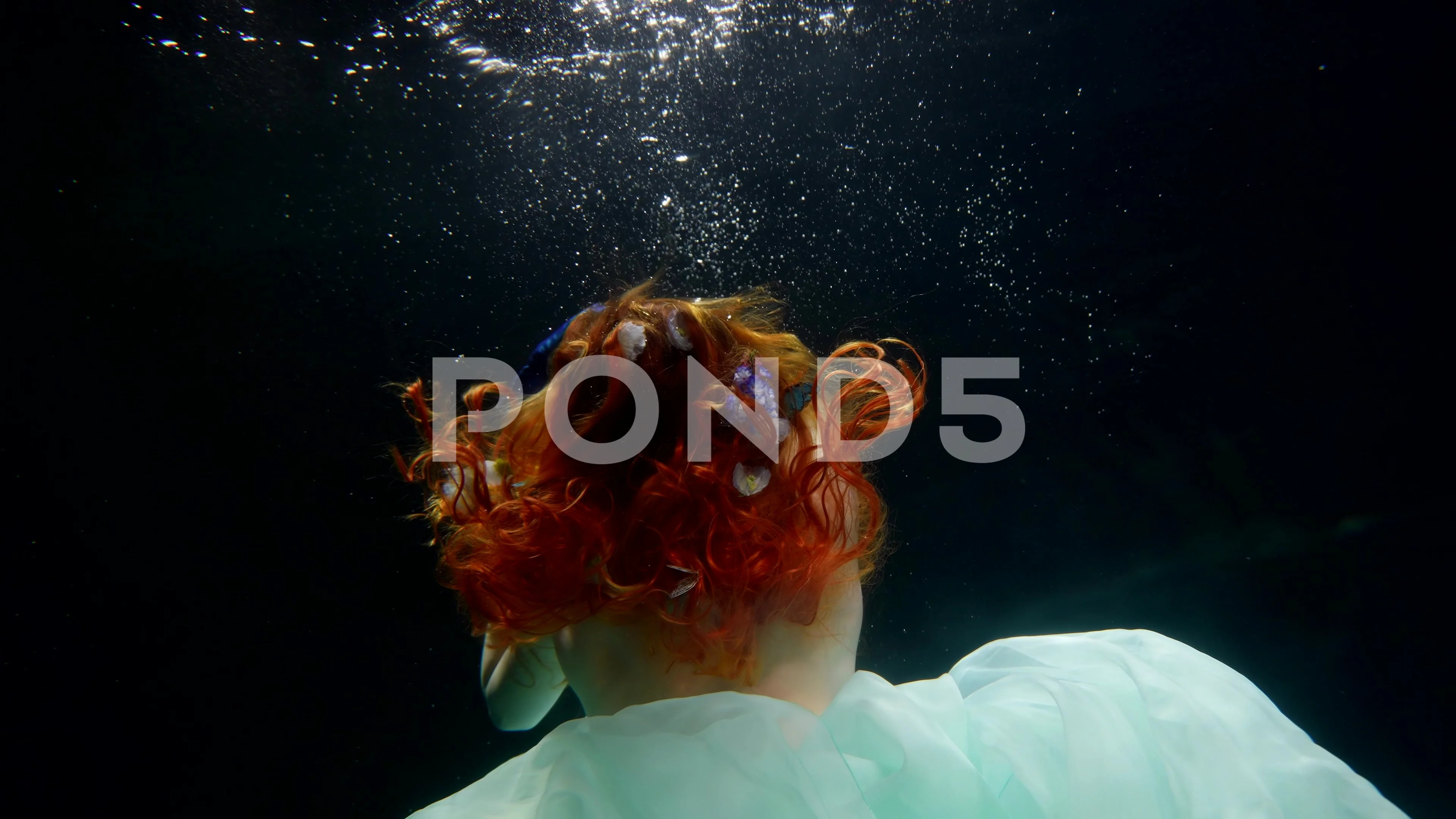 enigmatic woman figure with naked back and breasts floating in depth,  underwater