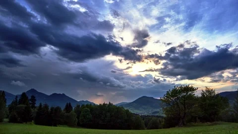Enjoy a breathtaking view of mountains under the dramatic clouds, creating a Stock Footage 294594690