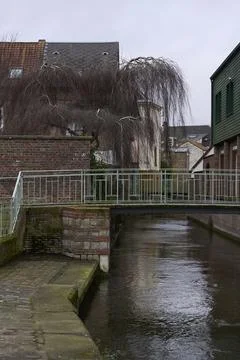 Enjoy the Charming Canal View featuring a Bridge and Overhanging Trees all .. Stock Photos