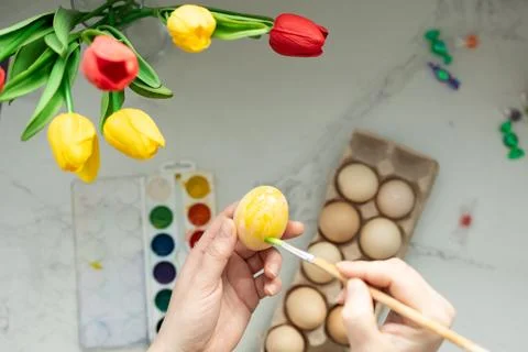 Enjoy decorating Easter eggs with beautiful tulips for a colorful and engaging Stock Photos