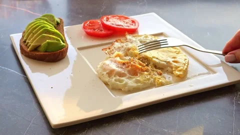 Enjoy a delightful breakfast spread featuring an omelette with tomatoes and Stock-Footage 270408518