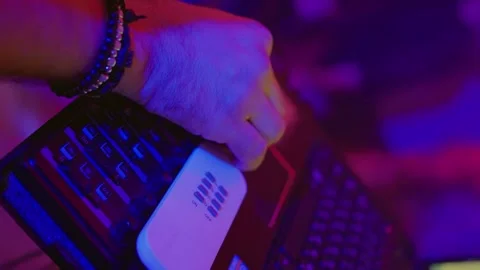 Enjoy a Dynamic DJ Performance Featuring Stunning Colorful Lighting Effects That Stock Footage 303707904