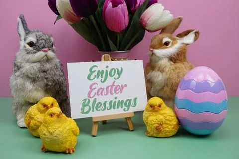 Enjoy Easter Blessings text with easter elements decoration on pink and gre.. Stock Photos