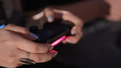 Enjoy an exciting gaming session with a handheld console full of thrills and Video stock 305864401