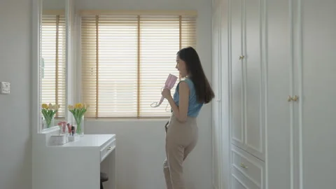 Enjoy good time dancing and singing in front of mirror and closet room Stock Footage 200184655