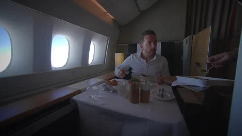 Enjoy a luxurious inflight dining experience in First Class while traveling Stock Footage 318895002