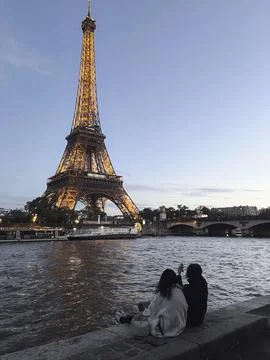 Enjoy a magical evening under the Eiffel Tower lights in Paris, perfect for.. Stock Photos