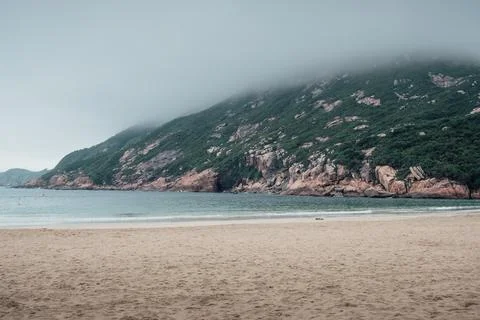 Enjoy the quiet environment of the beach on a cloudy day Stock Photos
