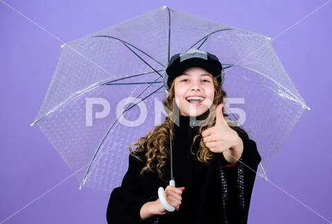 Enjoy rain concept. Fall season. Kids fashion trend. Love rainy days. Kid girl Stock Photos