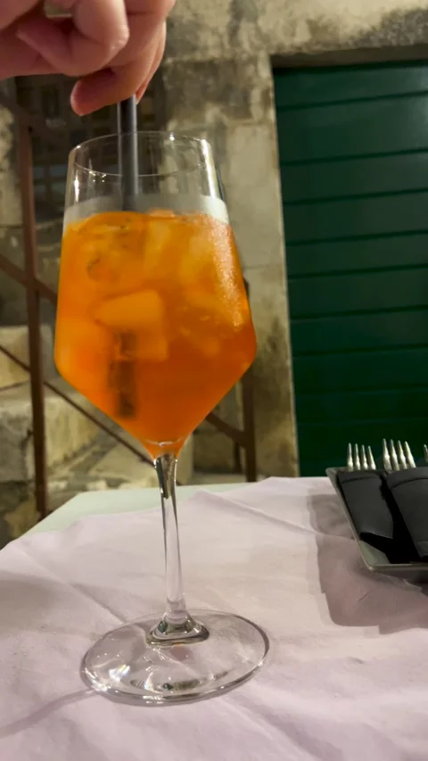 Enjoy a refreshing cocktail served in a stylish, eye-catching glass. Stock Footage 303664907