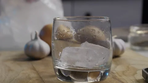Enjoy a Refreshing Drink Served Over Ice and Garlic on a Beautifully Crafted Stock Footage 306491508