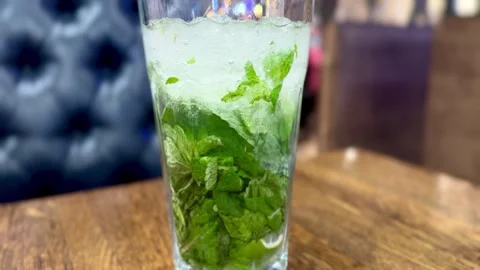 Enjoy a Refreshing Mint Mojito served in a Clear Glass that is perfect for any Stock Footage 316468609