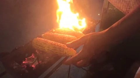 Enjoy roasted corn at night, Asian street food style Indonesia Stock Footage 196992932