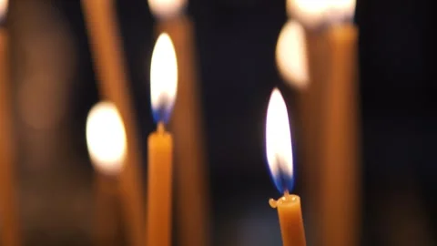 Enjoy the serene atmosphere created by observing candles burning up close in a Stock Footage 278016385