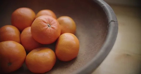 Enjoy the sight of Fresh Oranges beautifully arranged in Rustic Bowl Vídeos de archivo 299716180