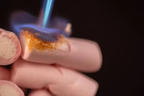 Enjoy the sight of marshmallows melting under the intense heat of a torch. .. Stock Photos