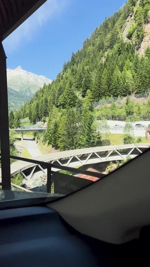 Enjoy the stunning mountain road view with vibrant greenery and a clear blue sky Stock Footage 307425001