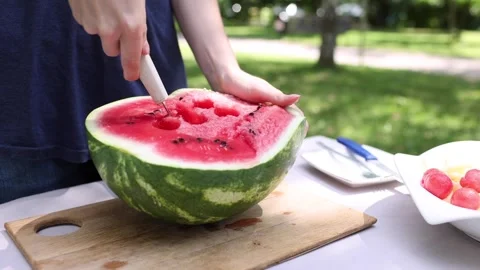 Enjoy the summer by preparing a fresh melon salad in the park Stock Footage 297365306