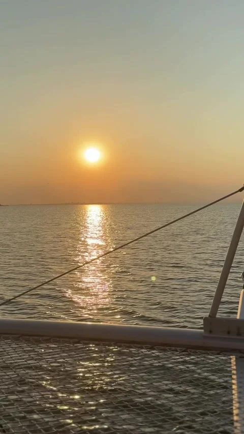 Enjoy a tranquil sunset view from a boat on the open sea, where golden hour.. Stock Footage 316923232