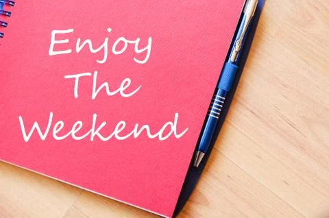 Enjoy the weekend write on notebook Stock Photos